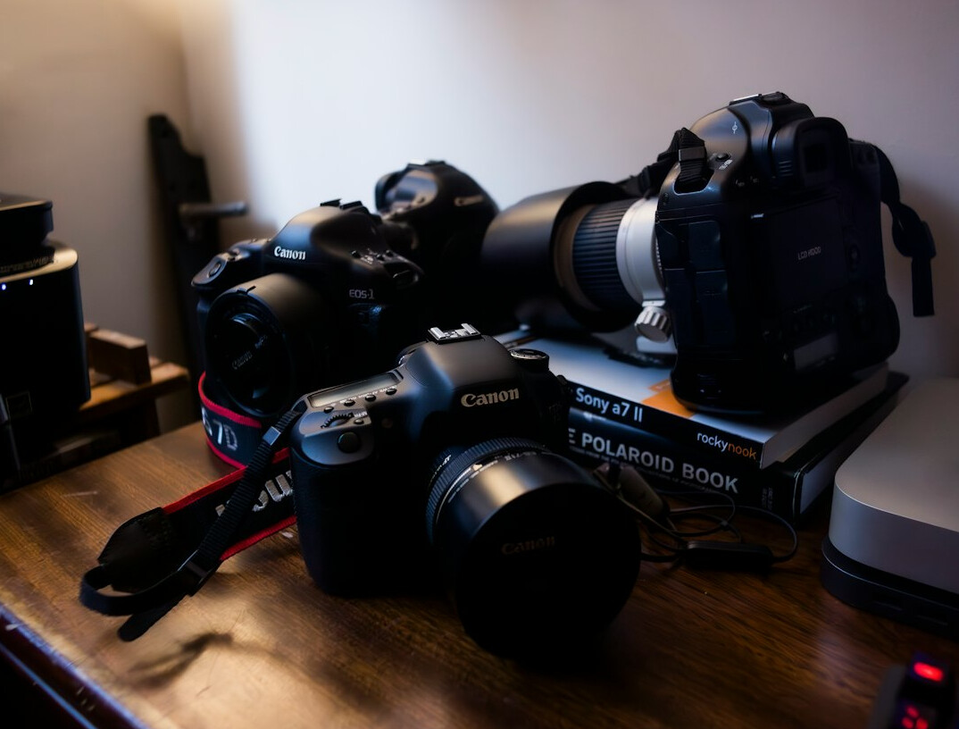 Rows of cameras and tripods ready on a studio floor