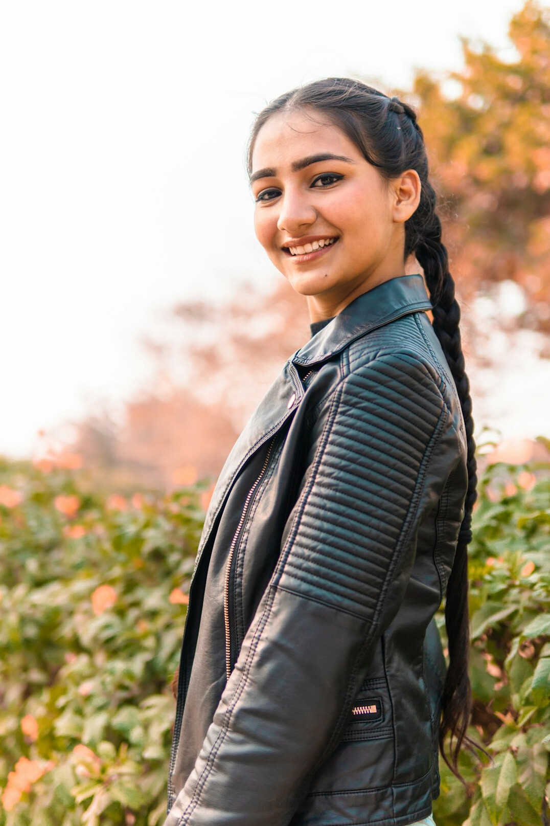 Portrait of a woman with long dark hair smiling at the camera